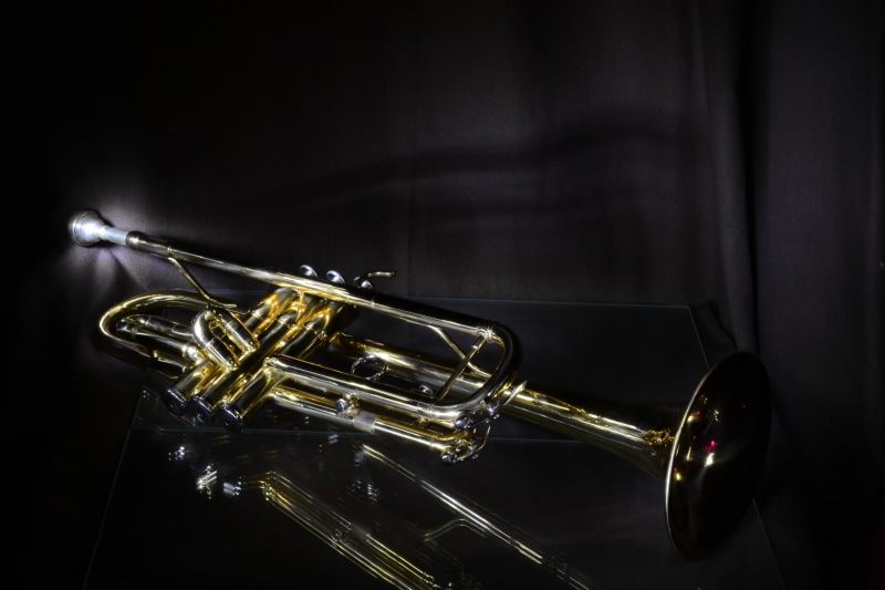 indoors, wind instrument, music, black background, black color, brass, studio shot, single object, saxophone, 4K, gold, black, musical instrument, surface