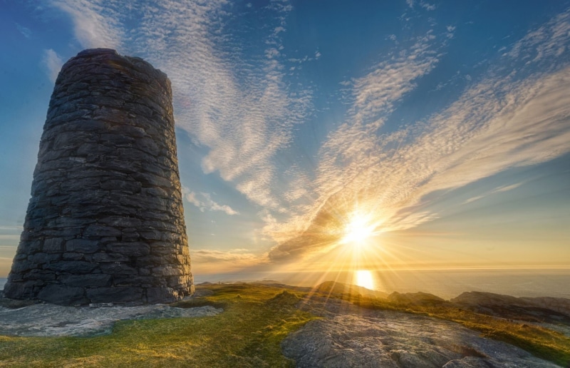 gray, sun rays, orange color, tower, cloud - sky, sunset, sunbeam, sunlight, low angle view, tranquil scene, lens flare, sun, storage, stone, no people