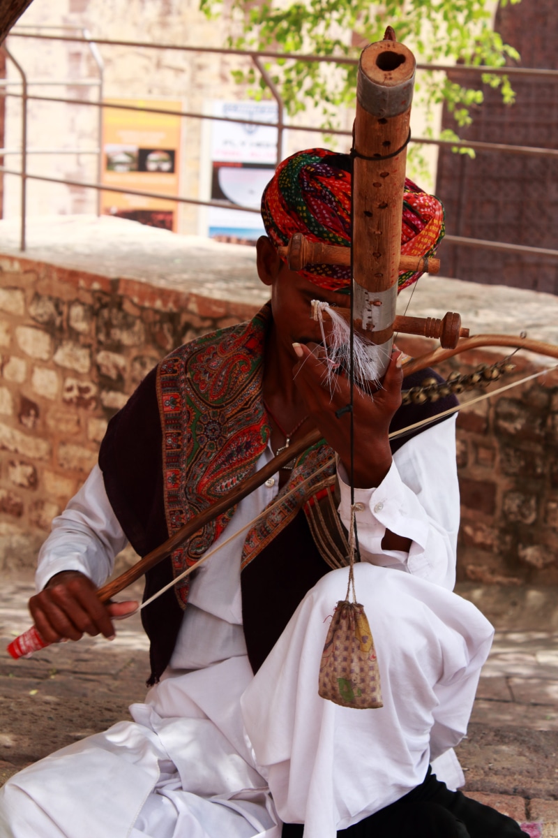 rajasthan, real people, weapon, front view, leisure activity, unrecognizable person, standing, clothing, 5K, day, music, one person, obscured face, holding