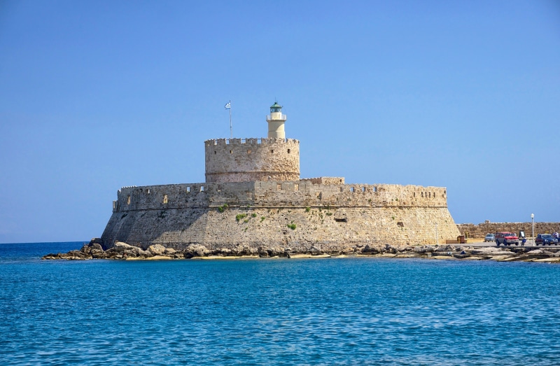 castle, clear sky, sea, sky, history, tower, body, rhodes, clouds, greece, travel destinations, water, outside, fortress, building, historic, outdoors