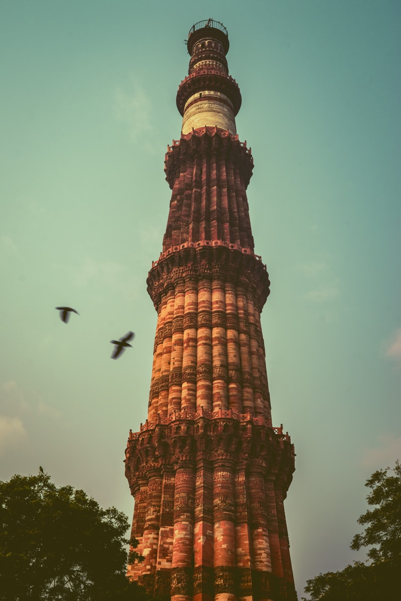 india, outdoors, travel destinations, sky, steeple, flying, blue, qutub minar, monument, lighthouse, tower, no people, structure, old, day, building, 5K