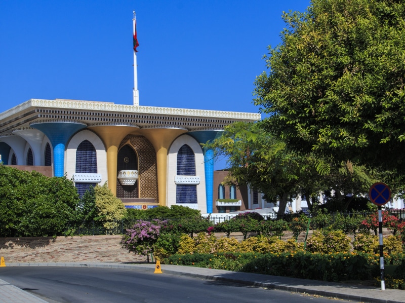 palace, sunlight, outdoors, city, street, building, building exterior, 4K, no people, sultan, blue, sky, muscat, day, patriotism, built structure, clear sky
