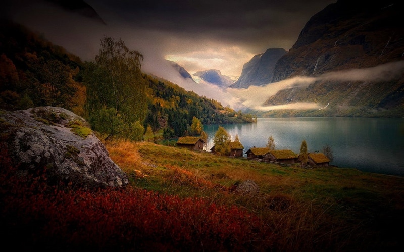 stone, tree, tranquil scene, lake, clouds, trees, environment, grass, no people, gray, water, cabin, mountains, cloud - sky, mountain range, nature, landscape