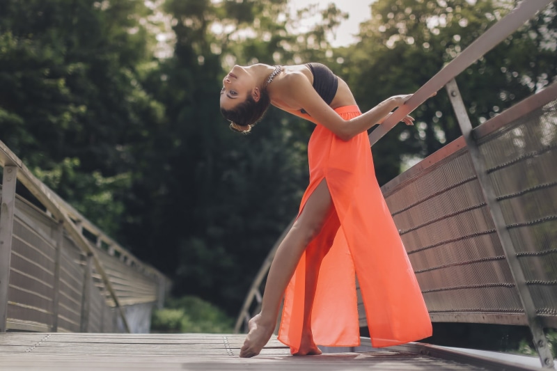 clothing, model, day, arms raised, full length, barefoot, architecture, brunette, young women, leisure activity, bridge, bent over, focus on foreground