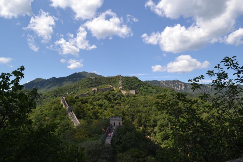 destination, tourism, mountain, great wall, built structure, land, environment, cloud - sky, wall, landmark, no people, mountain range, nature, plant, beauty in nature