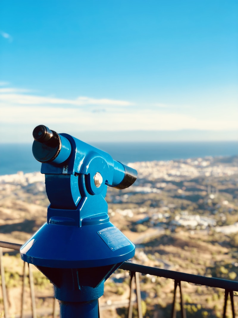 building exterior, furniture, focus on foreground, built structure, city, scenery, blue, hand-held telescope, landscape, cityscape, architecture, hydrant