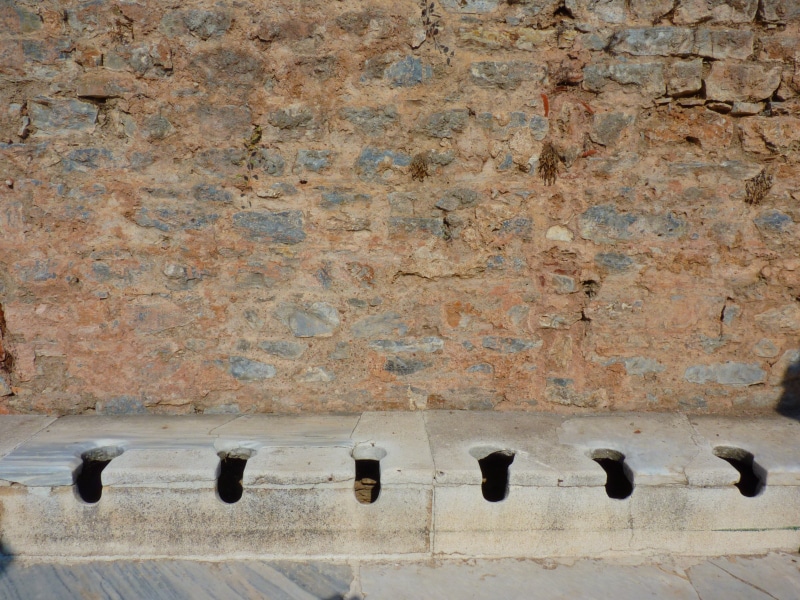 building exterior, wall - building feature, pigeon, metal, low angle view, wall, asia minor, sanitary facilities, outdoors, ephesus, ruin, weathered, temple of artemis