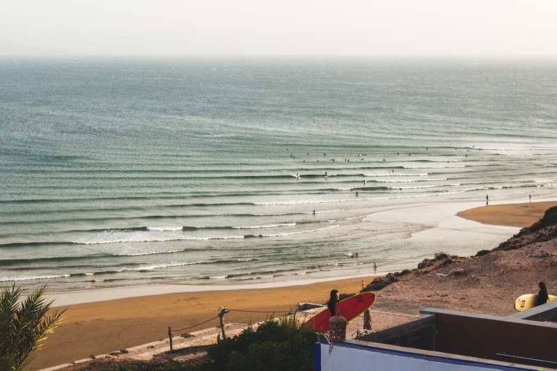 building, ocean, summer, view, serfing baord, tranquil scene, architecture, real people, land, lifestyles, tranquility, surfer, sea, high, imsouane, beauty in nature