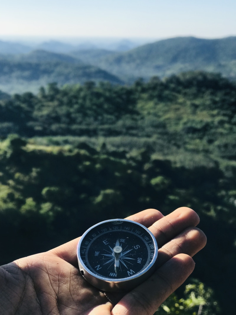 scenic, human finger, compass, person, guide, holding, body part, backpacker, water, discovery, nature, expedition, leisure, mountains, time, real people