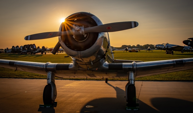 no people, sunlight, outdoors, air vehicle, airport runway, airport, fighter, flying, metal, military, ww2, sky, sunset, vintage, sun, nature, mode of transportation