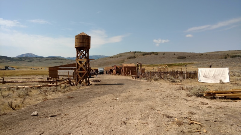 outdoors, field, Western, town entrance, desert, day, non-urban scene, agriculture, landscape, sky, old west, land, western movie set, dirt road, Movie
