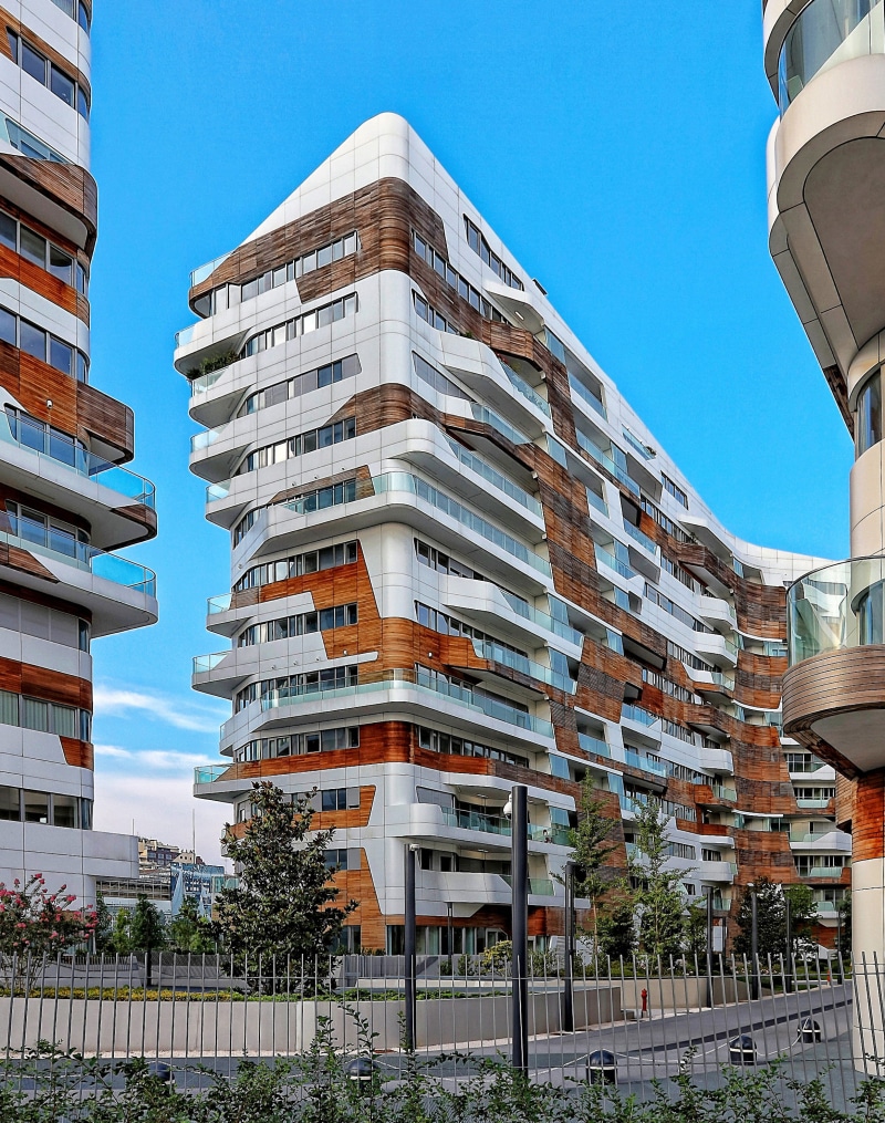 wodd, 2K, residential district, building, outdoors, facade, railing, balcony, apartment, glass, milan, sky, sunlight, clear sky, plant, tree, day, window