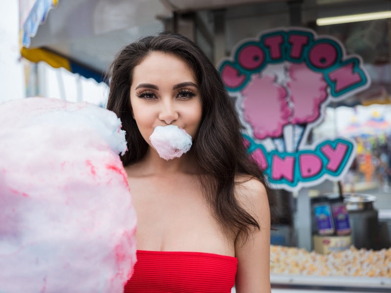 looking at camera, candy, 720P, brown hair, portrait, lifestyles, one person, cotton candy, face, brunette, popcorn, women, young adult, front view, smiling