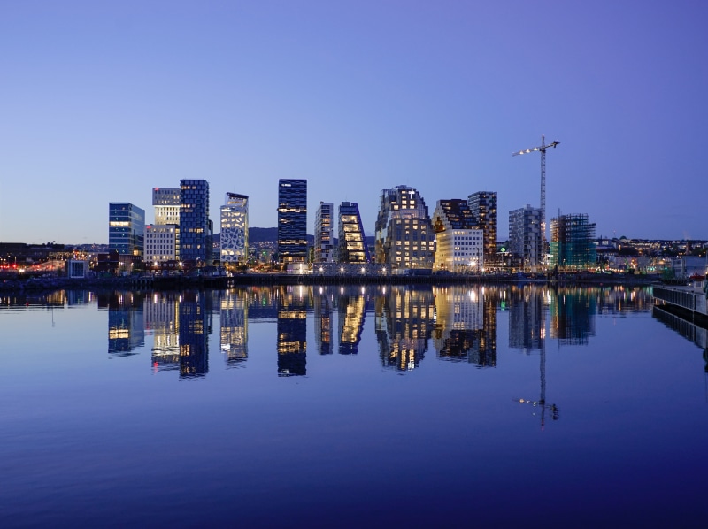 calm, sky, buildings, skyline, building, dusk, outdoors, urban, skyscraper, building exterior, cityscape, mirror, blue, apartment buildings, no people