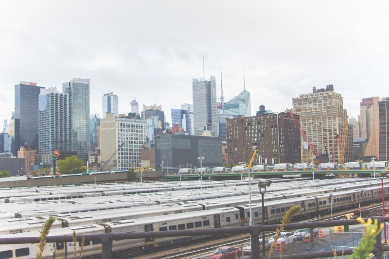 traffic, building, railroad track, train - vehicle, rail transportation, travel, transportation, metropolitan area, building exterior, landscape, architecture