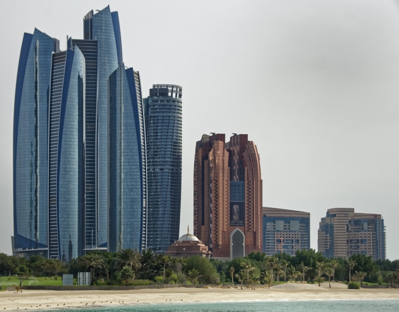 tree, building exterior, plant, office, architecture, abu dhabi, financial district, built structure, clear sky, tower, city, building, nature, no people