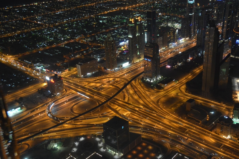 high angle view, tower, traffic, building exterior, vehicles, road, modern, financial district, urban Scene, car, architecture, connection, highway, illuminated