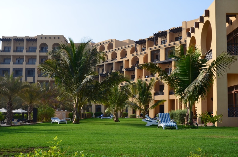 sun, building, architecture, city, transportation, land, built structure, tree, residential district, no people, day, plant, house, palm tree, grass, apartment