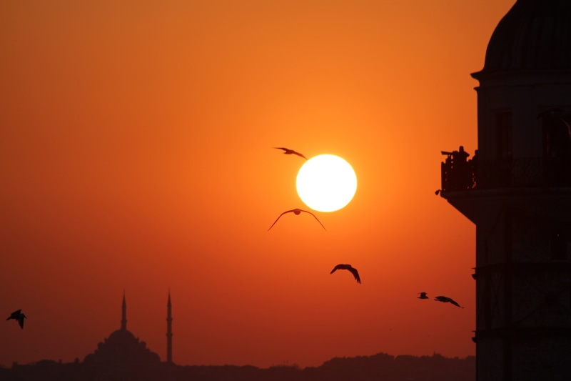 outdoors, no people, building exterior, silhouette, mid-air, the minarets, nature, flying, hour, sky, bird, cami, maidens tower kiz kulesi, golden, built structure
