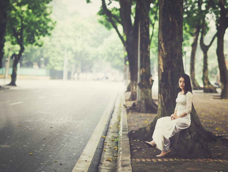 full length, adults, girl, one person, beautiful woman, sitting, hairstyle, woman, adult, 8K, plant, dress, young women, day, people, outside, beside