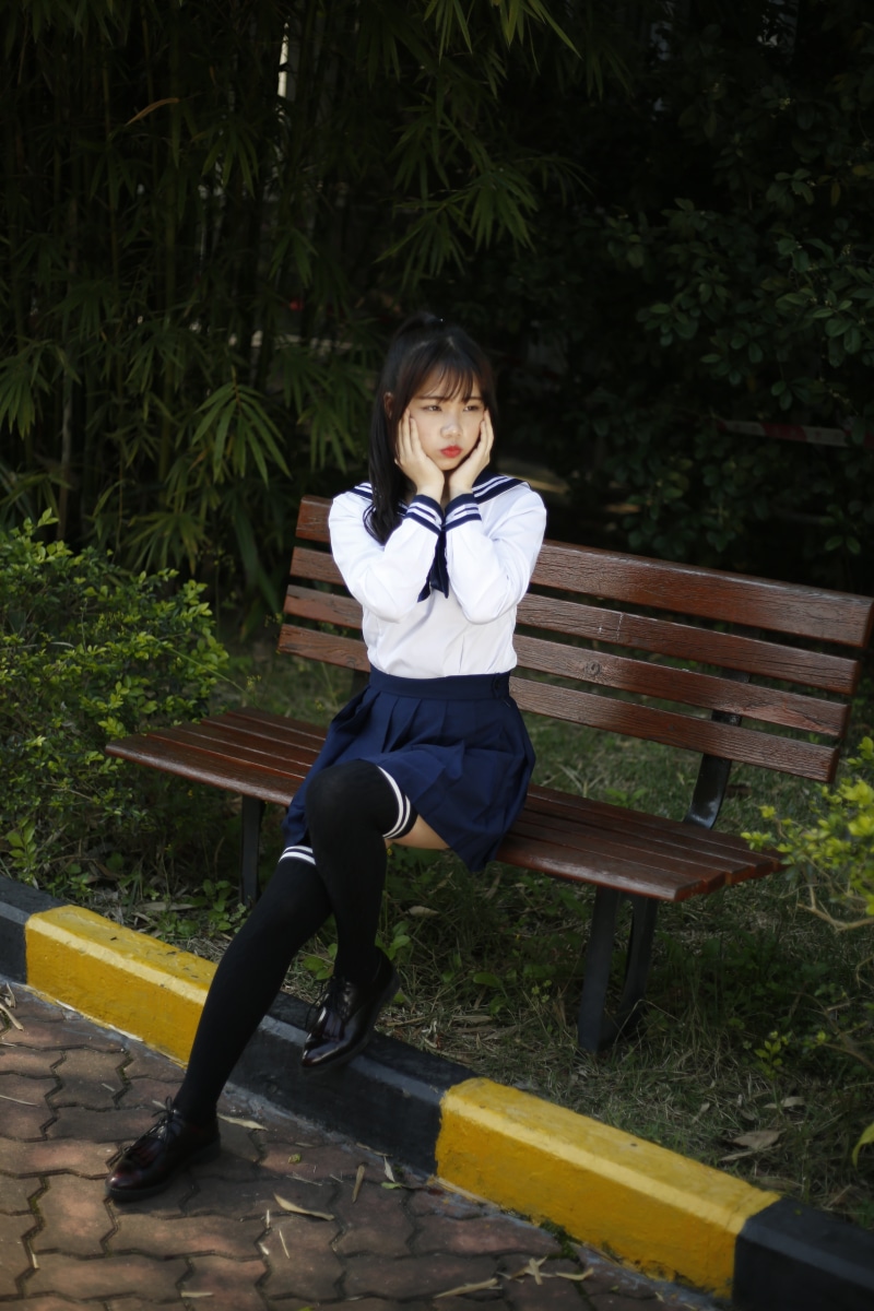 front view, smiling, women, uniform, wood - material, casual clothing, one Person, sad, full length, student, nature, real people, young women, people