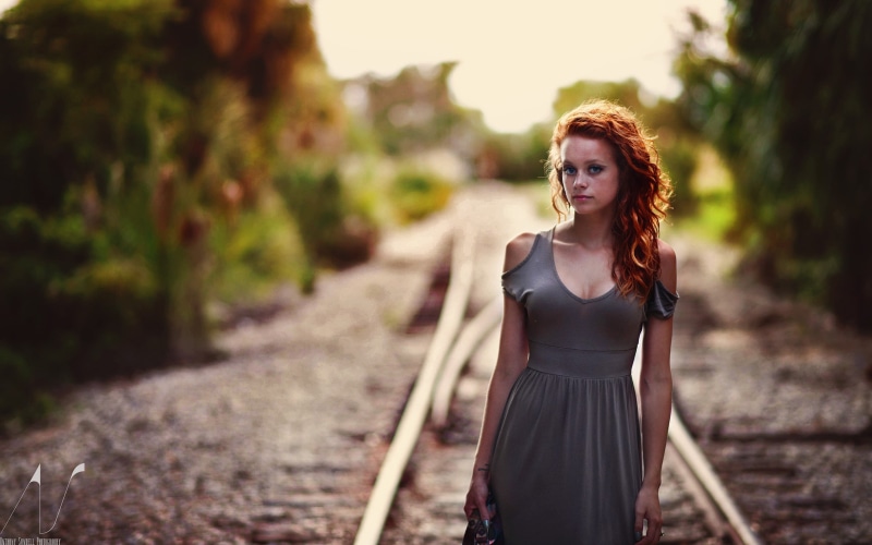 railway, women, bare shoulders, 2K, redhead, model, long hair, depth of field, wavy hair, Anthony Sundell, cleavage, grey dress, blue eyes