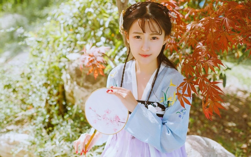 waist up, looking at camera, one person, portrait, childhood, holding, females, nature, bangs, 720P, real people, women, front view, day, Chinese dress