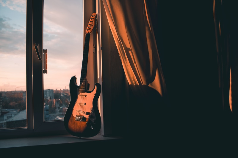 sky, beside, window, stage, indoors, musical instrument string, electric guitar, curtain, instrument, acoustic guitar, stringed instrument, nature, musical equipment