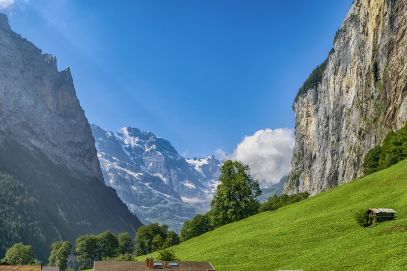 cloud - sky, beauty in nature, green color, landscape, no people, mountain, valley, lauterbrunnen, idyllic, environment, rock, non-urban scene, outdoors