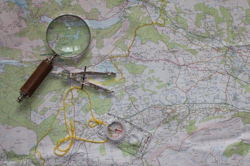 table, geography, reading, wood - material, adventure, green color, close-up, hiking, ruler, navigation, still life, magnifying glass, no people, man made