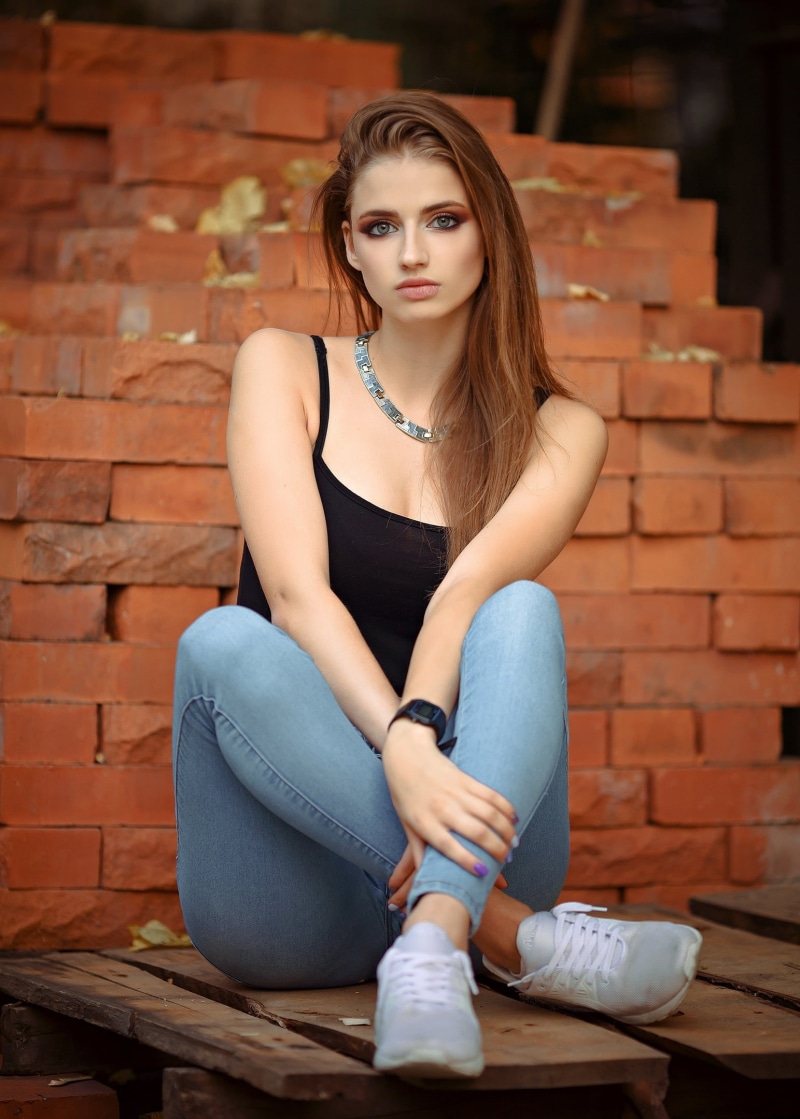 painted nails, tank top, denim, jeans, brunette, bricks, model, Dmitry Sedykh, long hair, black tops, women, watch, Casio, sitting, necklace, sneakers