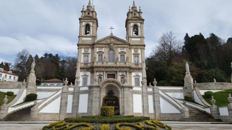 travel destinations, no people, building exterior, spire, spirituality, day, low angle view, tree, bom jesus, sky, the past, architecture, nature, sanctuary