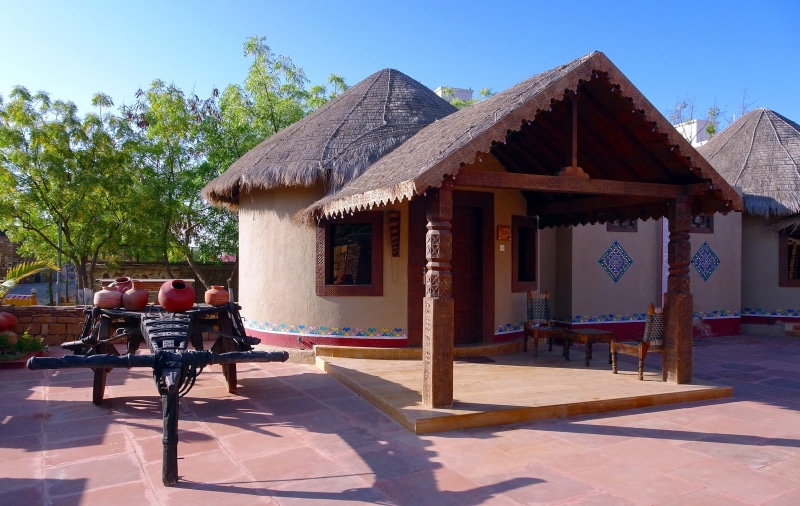 luxury, seat, tourist resort, adult, day, 2K, shadow, outdoors, built structure, building, tropical climate, sitting, bhunga, sky, group of people, gujarat