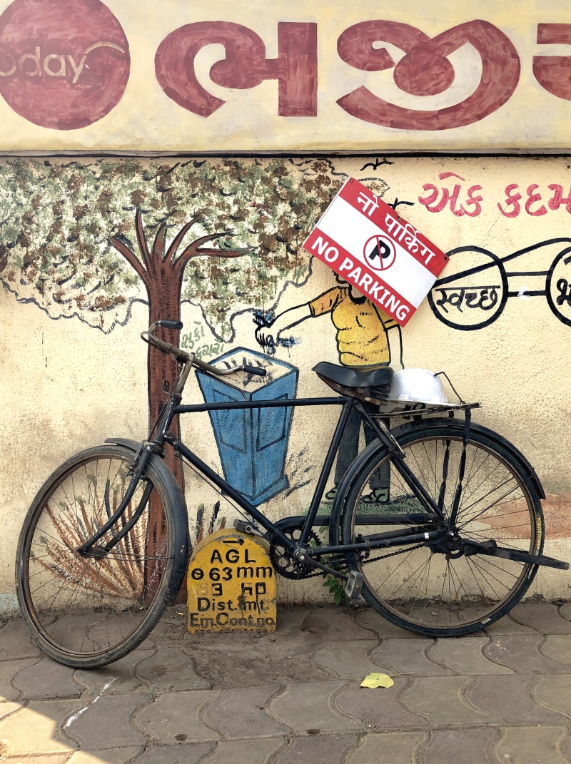 machine, stationary, india, bike, art and craft, vehicle, western script, roadside, sign, parkedbicycle, communication, cycle, outdoors, land vehicle, script