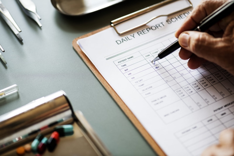 health, paper, checking, holding, data, table, finger, person, close-up, high angle view, human body part, desk, paperwork, checklist, filling, schedule