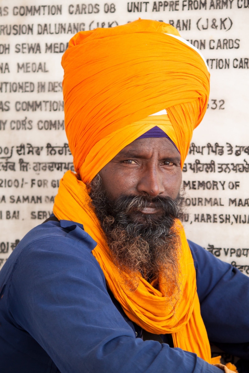orange, beard, portrait, western script, facial hair, men, sikh, text, 2K, amritsar, close-up, looking at camera, front view, clothing, adult, lifestyles