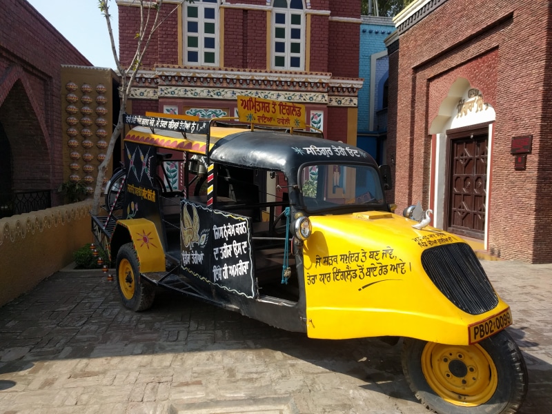 communication, building, yellow, building exterior, parking, Auto, city, Autos, Love, public transportation, text, Punjab Culture, outdoors, mode of transportation