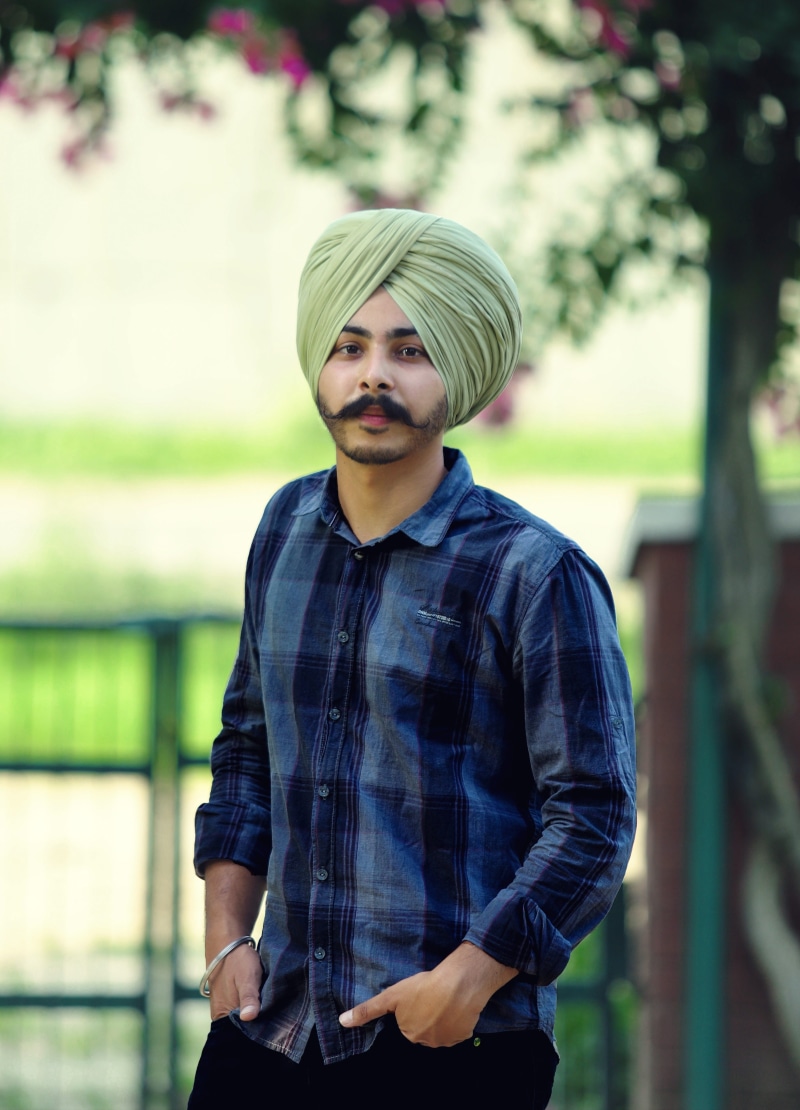 waist up, sardar, turban, plant, ludhiana, outdoors, focus on foreground, casual clothing, button down shirt, 4K, standing, day, young men, looking at camera