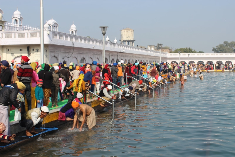 building exterior, large group of people, men, women, day, architecture, transportation, real people, built structure, travel destinations, turban, india