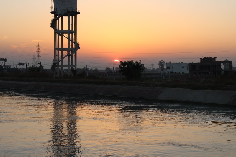 water, water tower - storage tank, water tank, sunset, beauty in nature, tranquility, no people, silhouette, tower, river, architecture, built structure