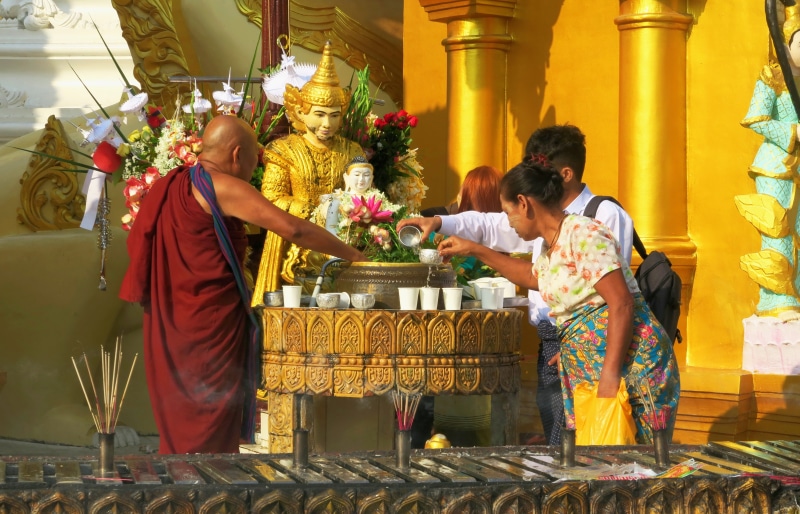food and drink, shwedagon, praying, adult, shrine, selling, font, real people, water, spiritual, leisure activity, men, belief, myanmar, food, prayer, outdoors
