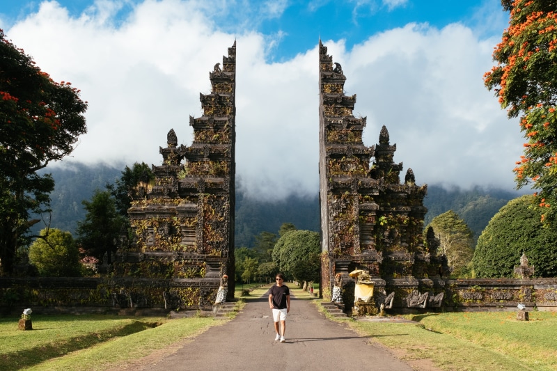 tourism, lifestyles, gate, day, fitness, outdoors, working out, cloud - sky, temple, sport, bali, white, indonesia, exercise, place of worship, leisure activity