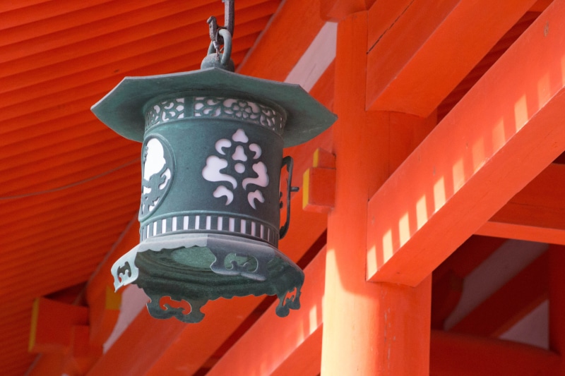 low angle view, outdoors, japan, built structure, close-up, non-western script, day, red, architecture, kyoto, shrine, nature, orange color, electric lamp