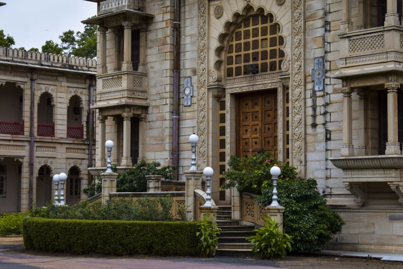 building exterior, history, outdoors, residential district, statue, the past, architecture, kirti mandir, sculpture, window, building, tree, growth, india