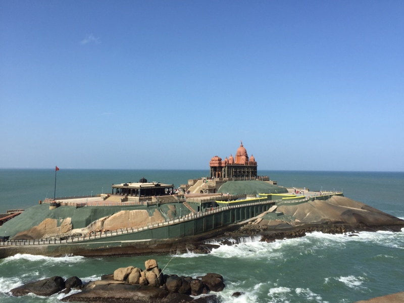 sky, beauty in nature, beach, wave, kanyakumari, built structure, water, horizon, temple, nature, no people, land, horizon over water, day, motion, travel destinations