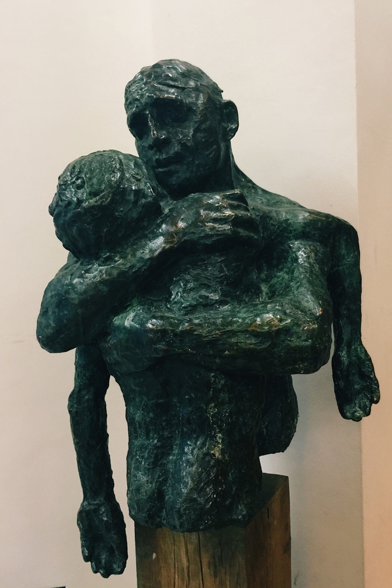 male likeness, wall - building feature, bronze - alloy, indoors, 2K, close-up, history, day, creativity, craft, sculpture, prodigal son, representation