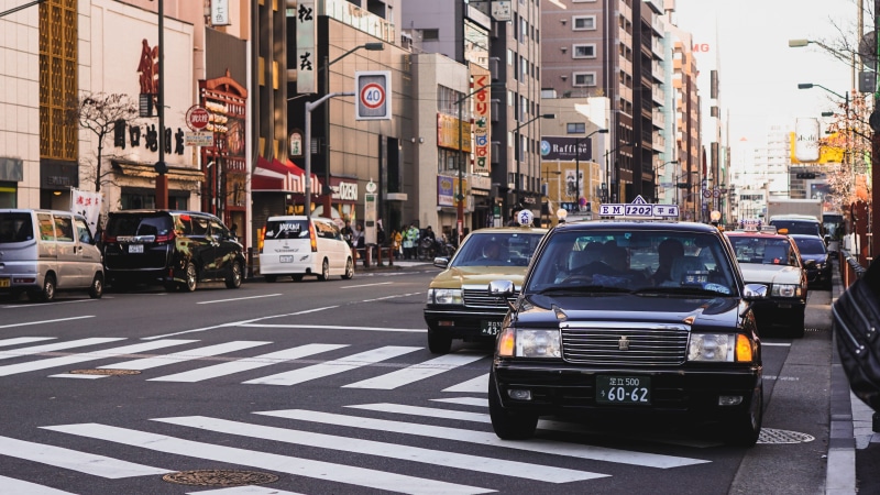 motor vehicle, tokyo, road marking, built structure, mode of transportation, city, crossing, incidental people, city street, road, transportation, zebra crossing