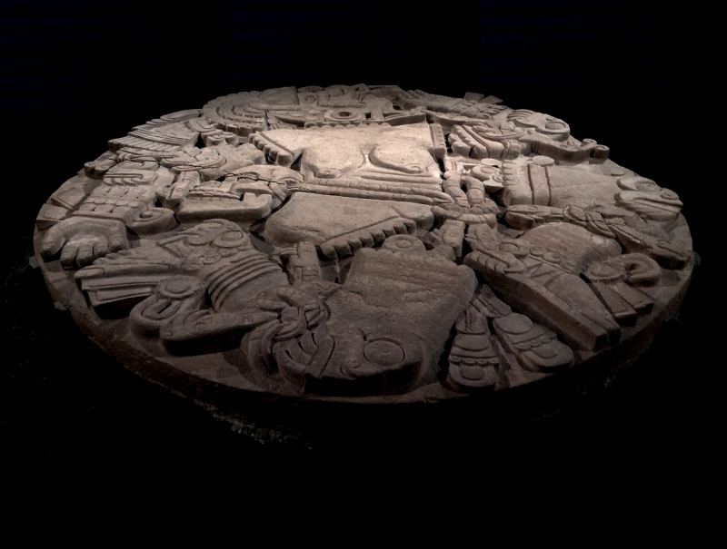 pre columbian, archaeology, no people, display, historical, sculpture, america, coyolxauhqui, indoors, ancient civilization, male likeness, black background