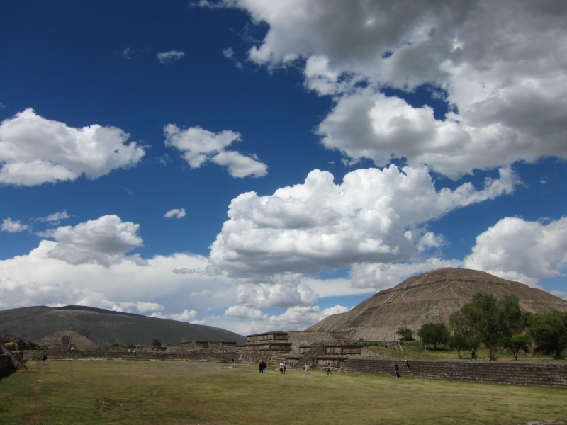 architecture, tranquil scene, pyramid, blue sky, field, beauty in nature, cloud - sky, non-urban scene, travel destinations, mountain, built structure