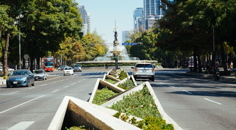 incidental people, day, lane, road marking, mode of transportation, building exterior, motor vehicle, fountain, street, office building exterior, nature